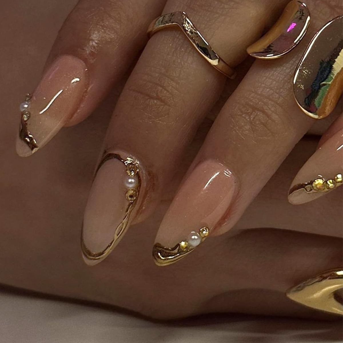 LRKNNO close-up of gold French tip and 3D pearl accents for elegant look