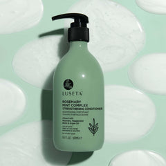 Hand holding LUSETA bottle to show 16.9oz scale and convenience