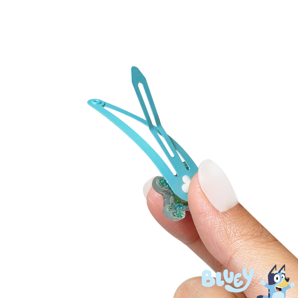 LUV HER clips in hand to show size and child-friendly scale benefit