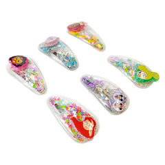LUV HER clip next to a coin illustrating compact size and child-appropriate scale