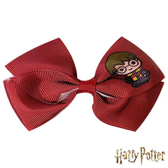 LUV HER bow in hand showing 4-inch scale for easy size reference