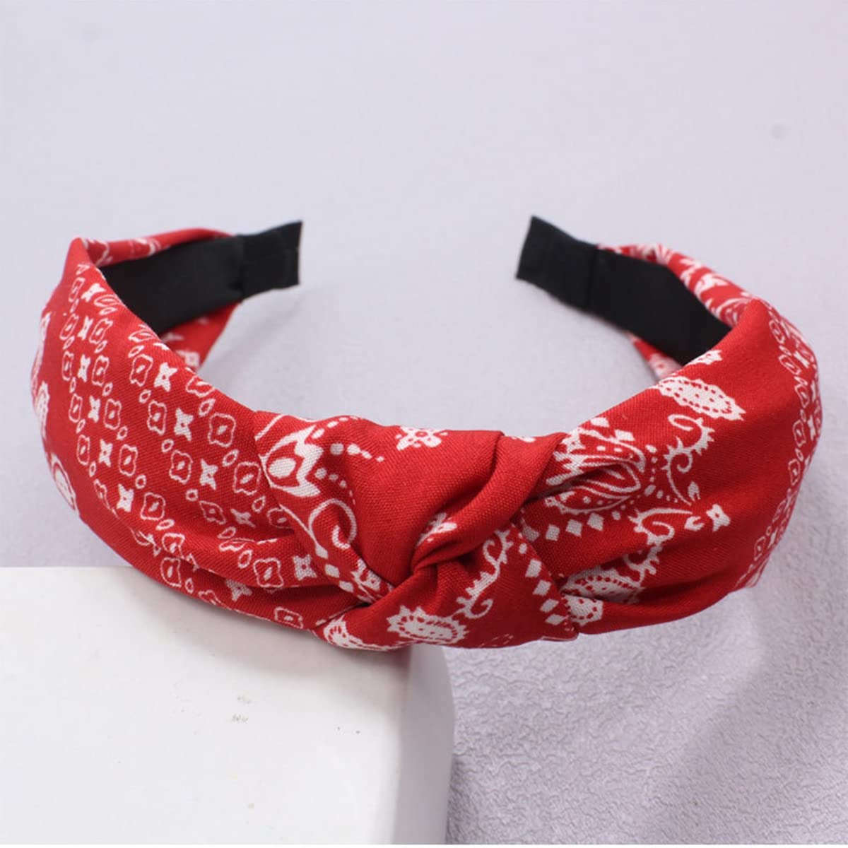 Lvyeer headband next to hand to show size and portable convenience