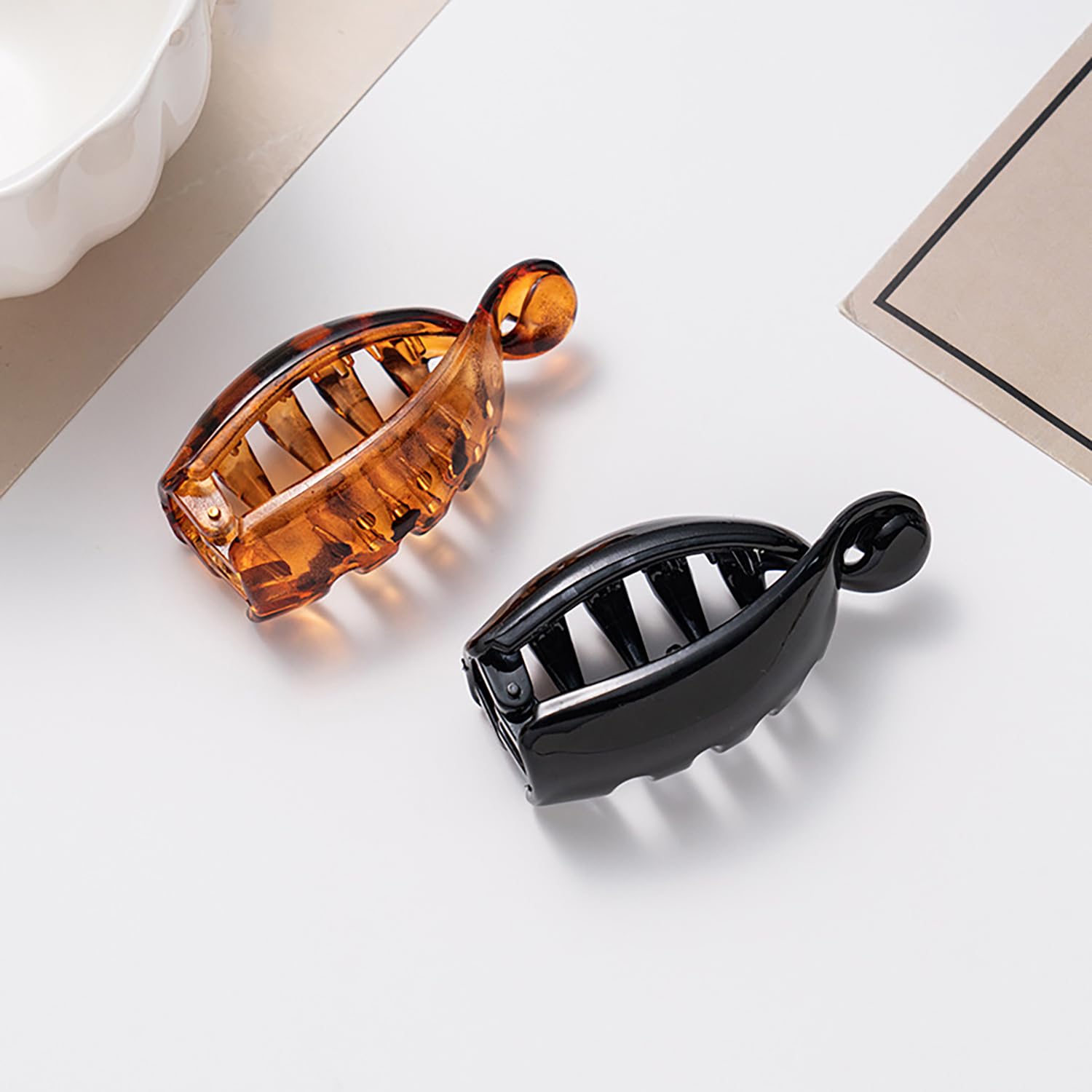LYLYNB clips held in hand showing compact size and travel-friendly benefit