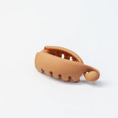 LYLYNB clip held between fingers to show size and travel convenience