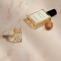 Maison Louis Marie bottle beside credit card showing compact 15ml travel benefit
