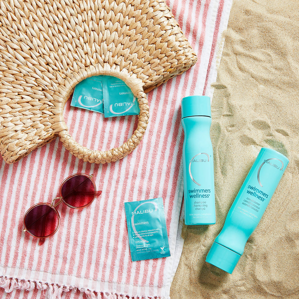 Malibu C bottle on bathroom shelf as part of a swimmers hair-care routine for convenience