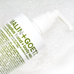 MALIN+GOETZ bottle set on shower shelf demonstrating routine use