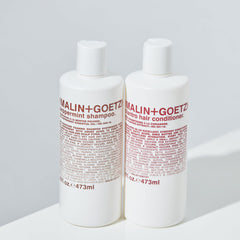 MALIN+GOETZ bottle styled in bathroom lifestyle scene suggesting everyday routine benefit