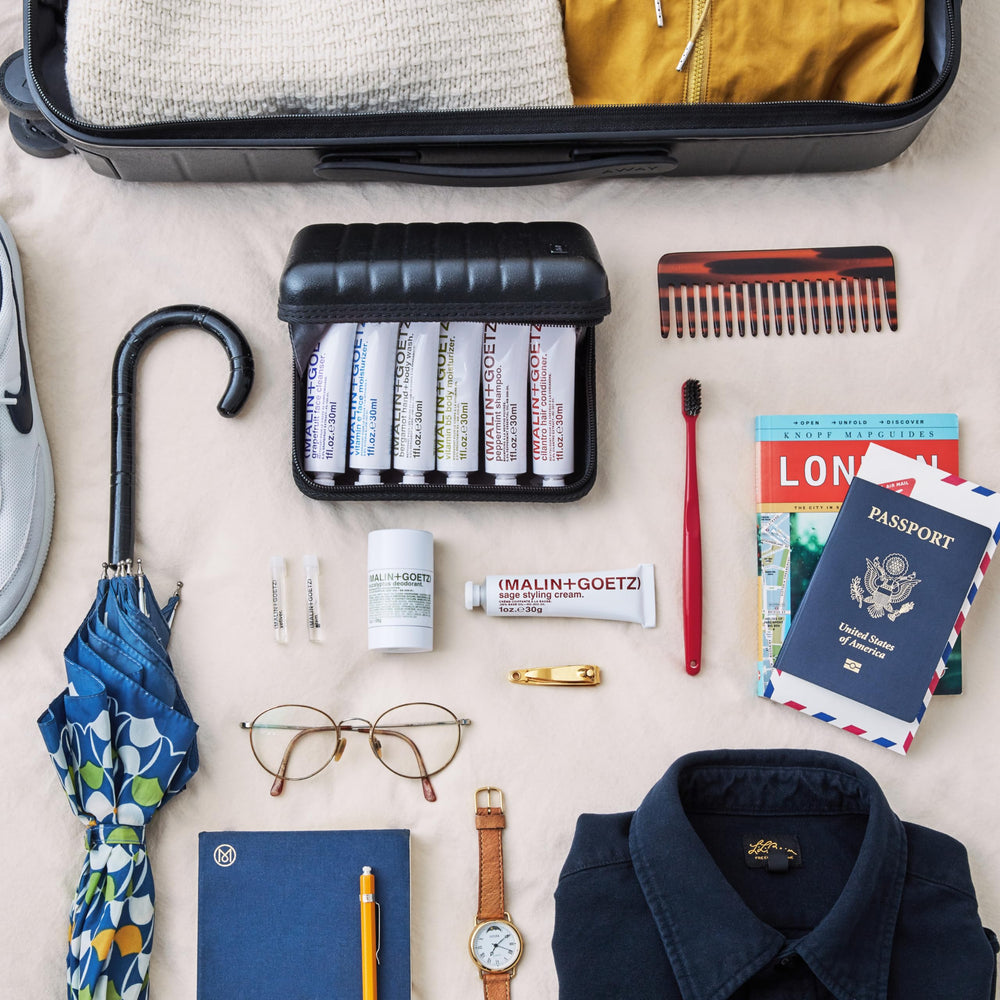 MALIN+GOETZ full travel kit inside a toiletry bag for organized on-the-go grooming