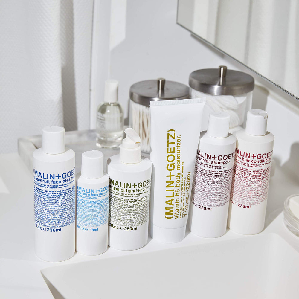 MALIN+GOETZ bottle staged in bathroom setting suggesting daily routine