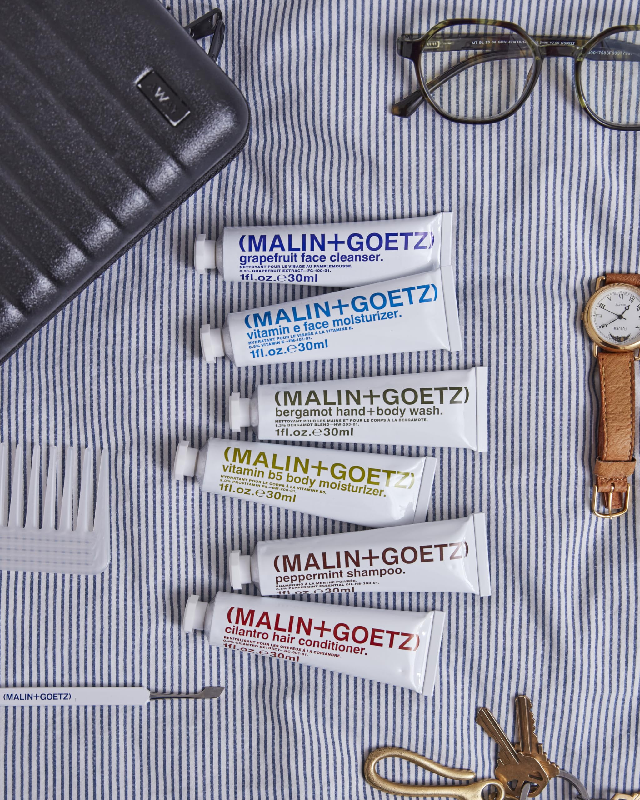 MALIN+GOETZ flatlay of natural ingredient components illustrating clean, vegan formulas