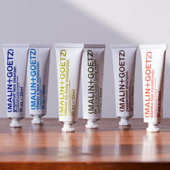 MALIN+GOETZ peppermint shampoo lathering in hand for refreshing hair cleansing