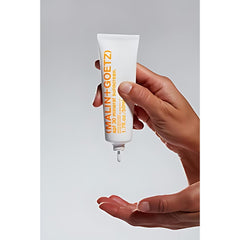 MALIN+GOETZ beside everyday items indicating compact travel-friendly SPF benefit