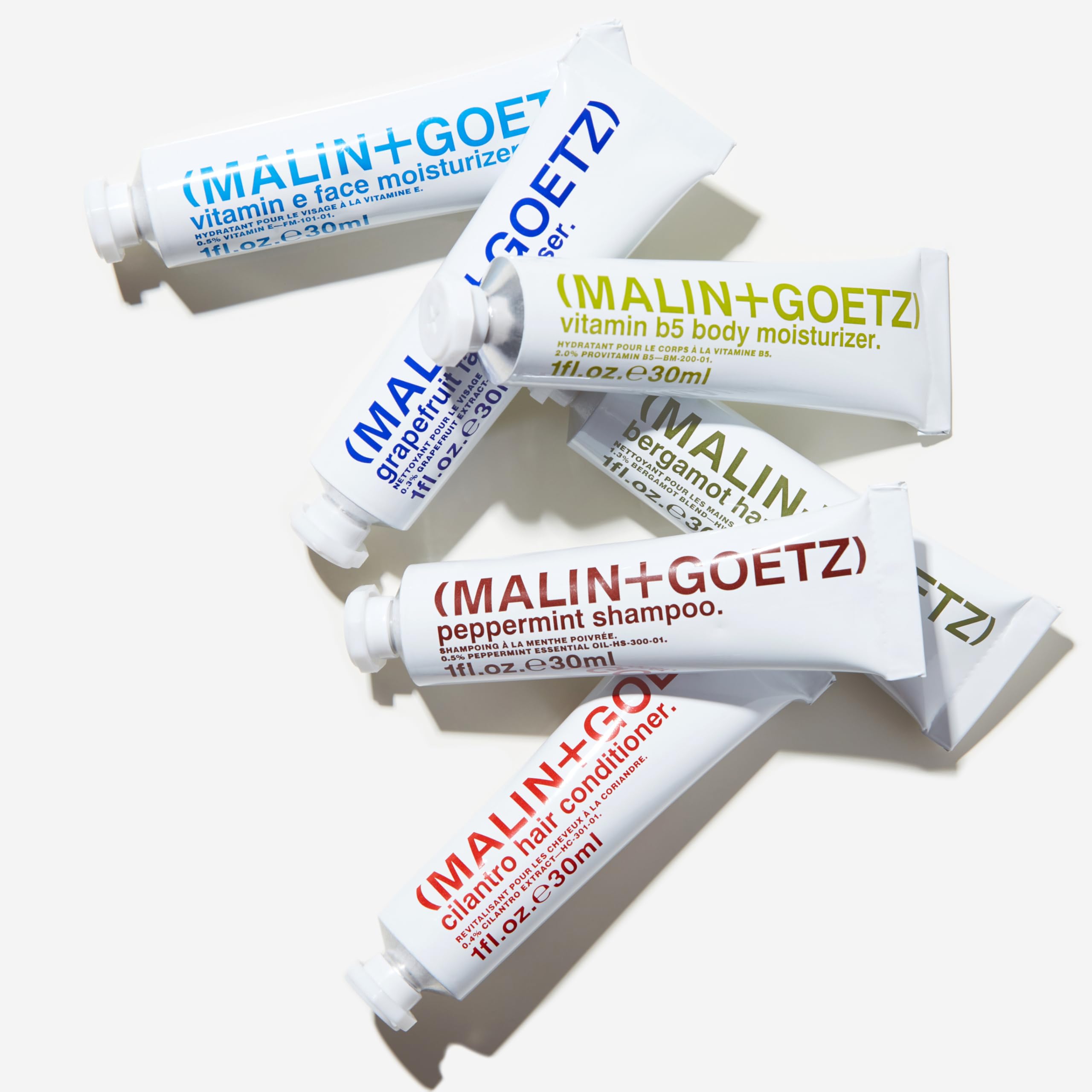 MALIN+GOETZ vitamin e face moisturizer cream texture on fingertip for lightweight hydration