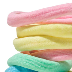 Mane hair ties held in hand for scale, illustrating extra-wide elastic and grip