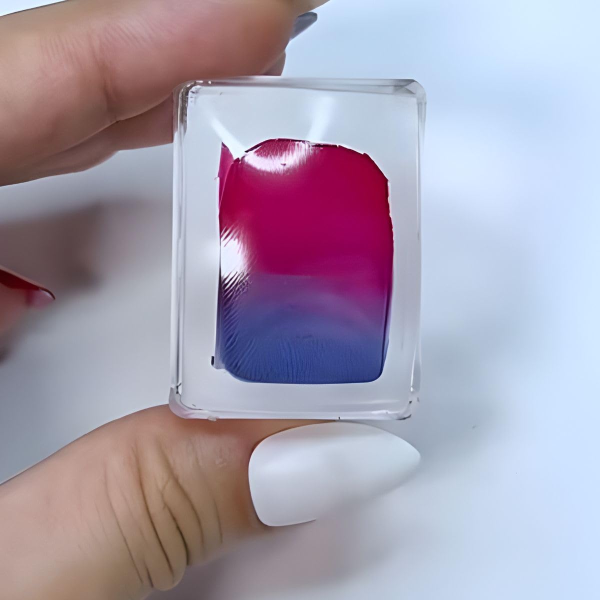 Maniology stamper next to a coin to show compact size and travel-friendly benefit