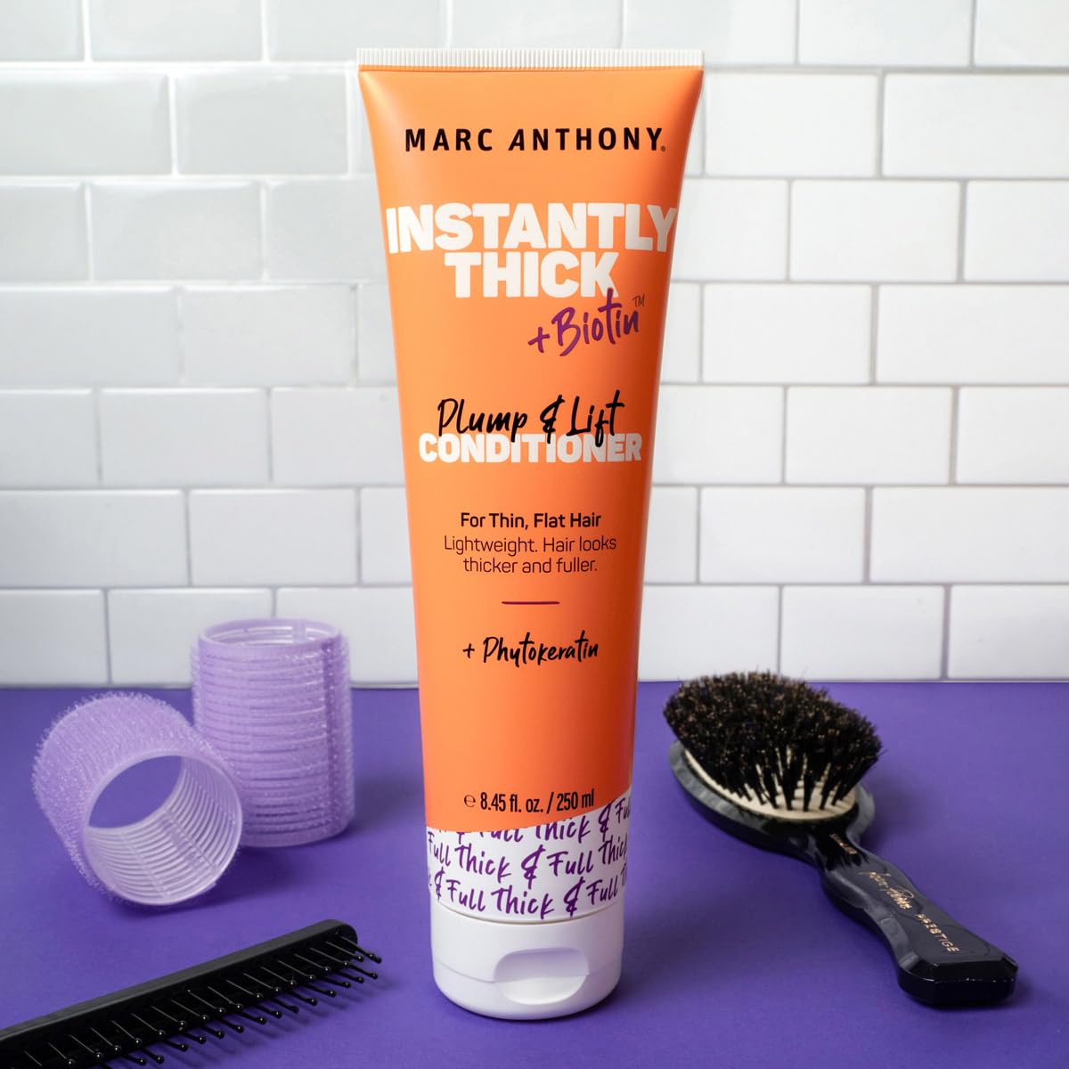 Marc Anthony conditioner being applied to wet hair for smoother detangling