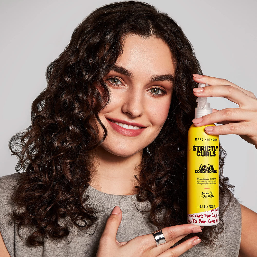 Marc Anthony used by woman with defined curls showcasing frizz control