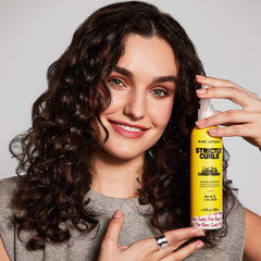 Marc Anthony used by woman with defined curls showcasing frizz control
