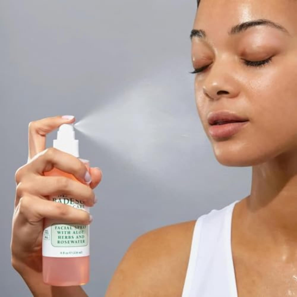 Mario Badescu bottle in hand to show true scale and travel-friendly portability benefit