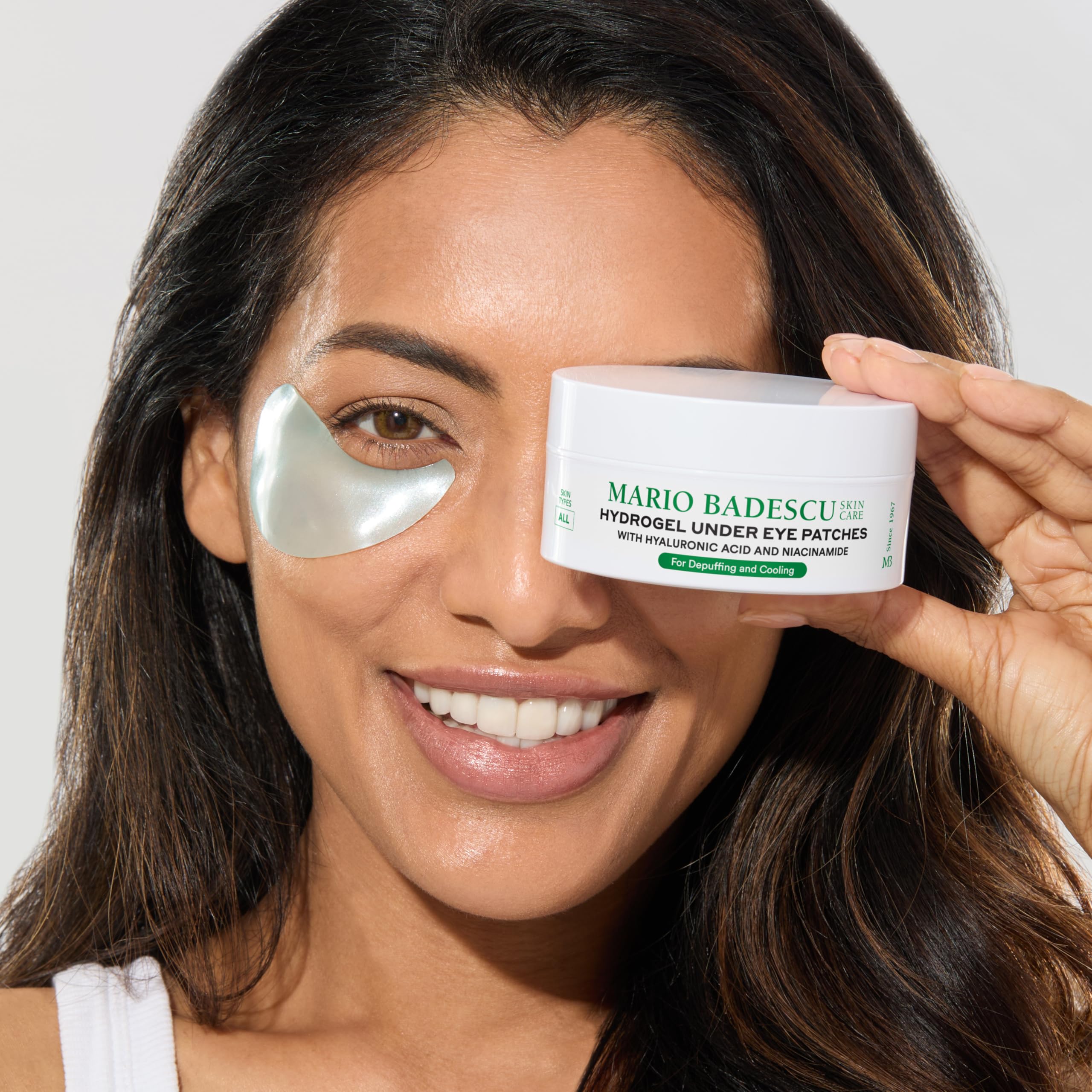 Mario Badescu patches applied under model eyes demonstrating cooling de-puffing effect