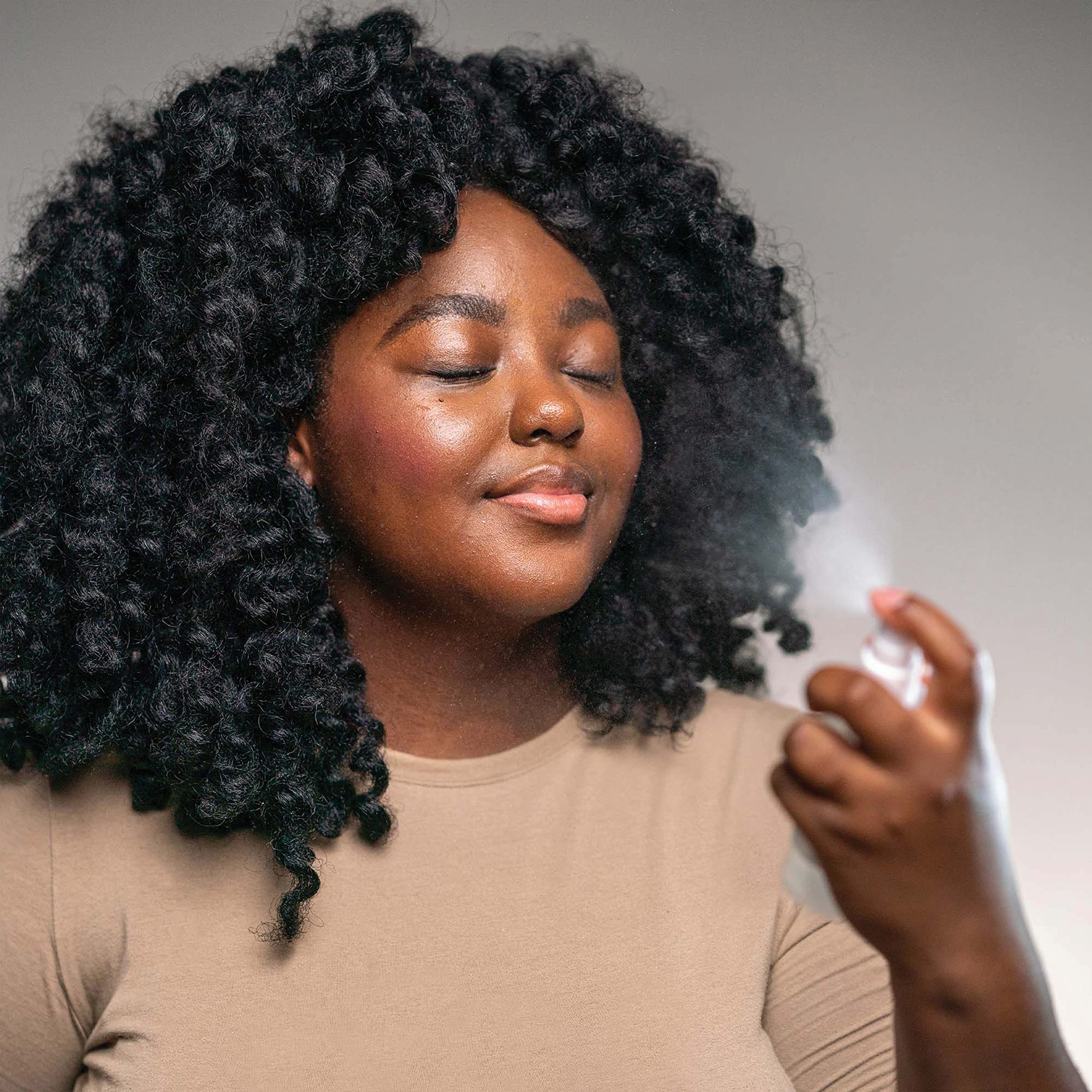 Mario Badescu mist sprayed from hand delivering instant skin refresh