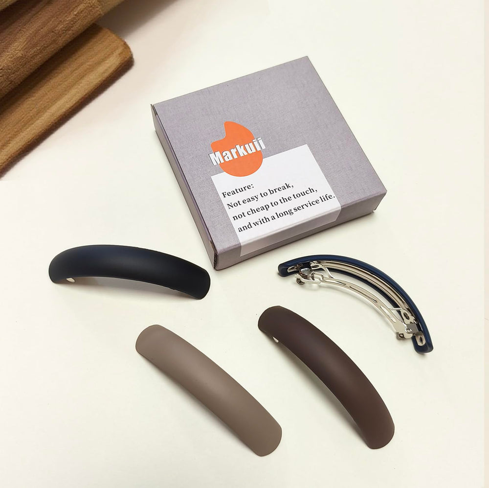 Markuii barrette held in hand for size and scale reference