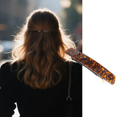 Markuii in-hair side profile demonstration holding a half-up section, maintains neat face-framing