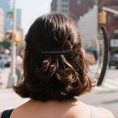 Markuii lifestyle shot with woman wearing clip for polished everyday style