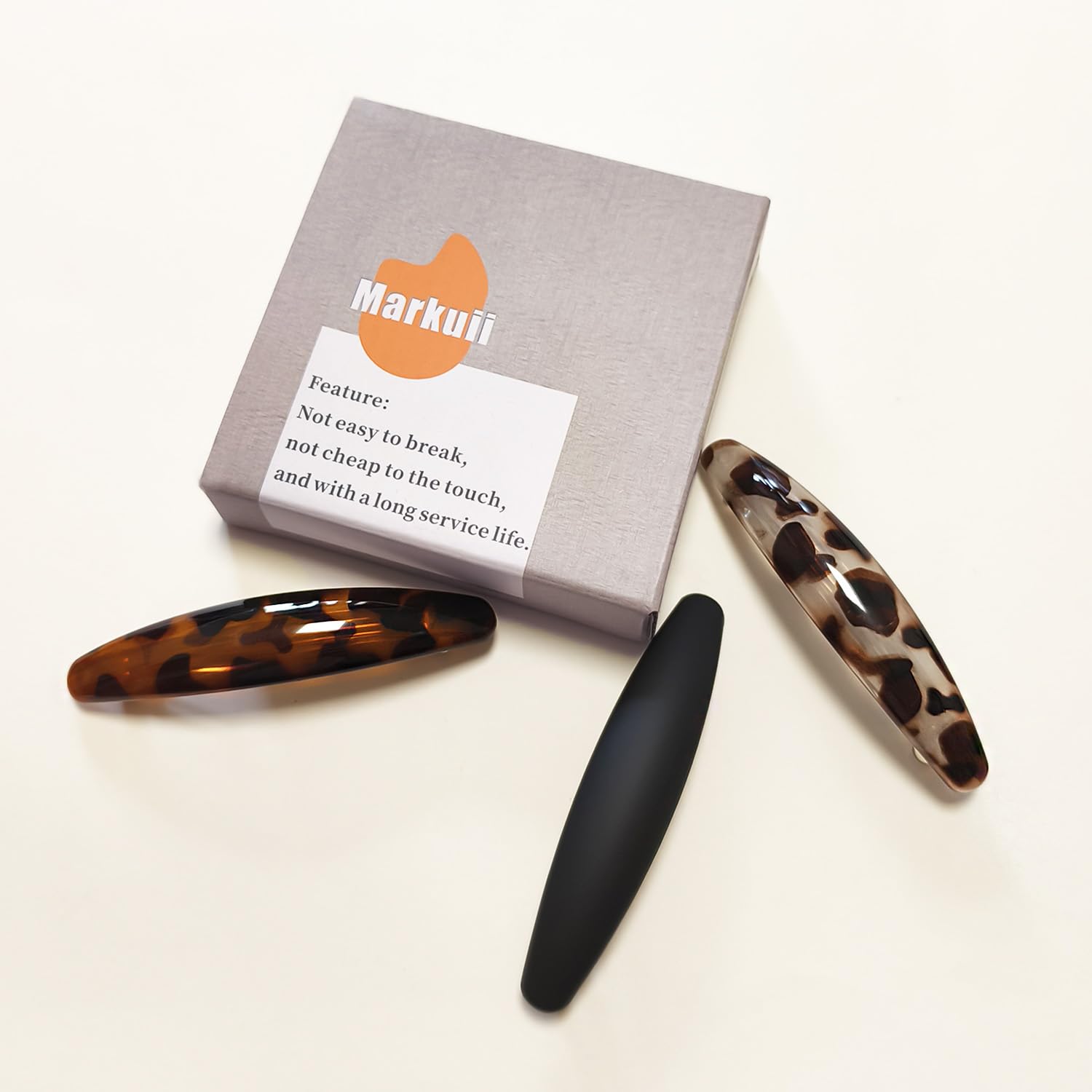 Markuii matte black barrette on model offering discreet professional hold