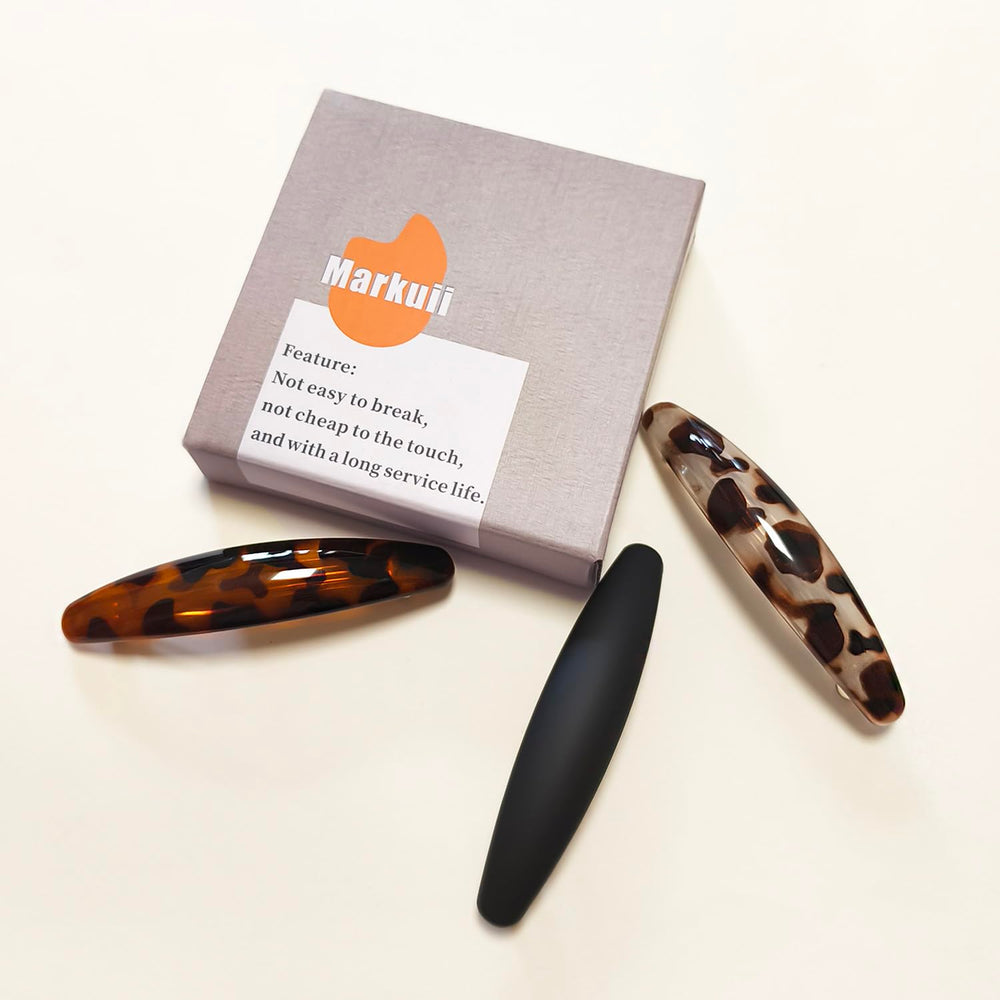 Markuii matte black barrette on model offering discreet professional hold