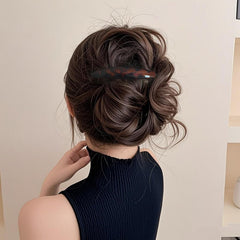 Markuii beside a coin to show 4-inch size for better hair coverage