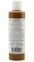 Maui Babe lotion in use on a sunlit beach showing application before tanning for enhanced color benefit