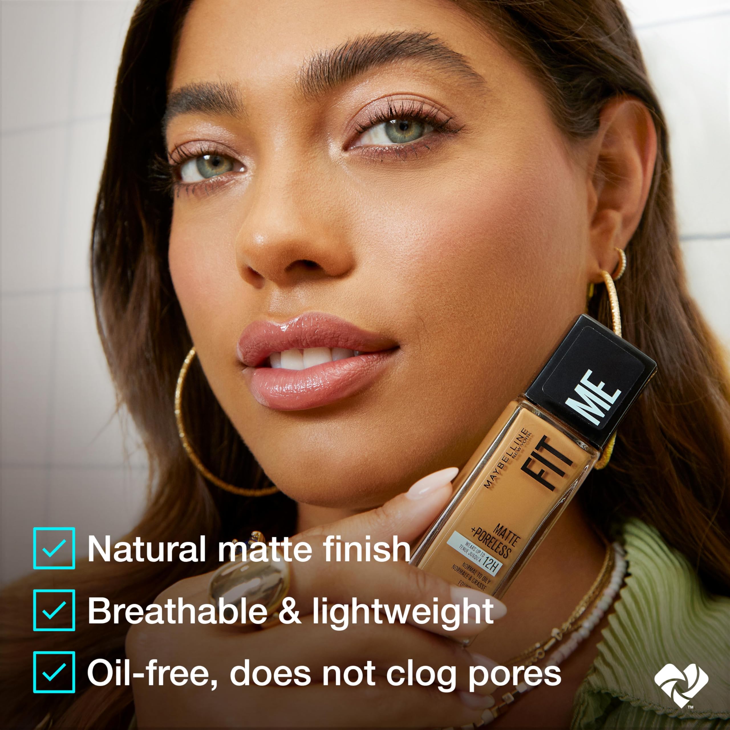 MAYBELLINE bottle next to everyday items showing size and travel-friendly scale