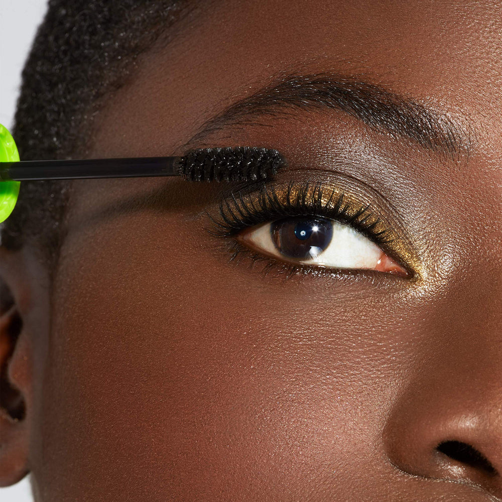 Maybelline lifestyle photo of woman applying mascara showing everyday glam benefit