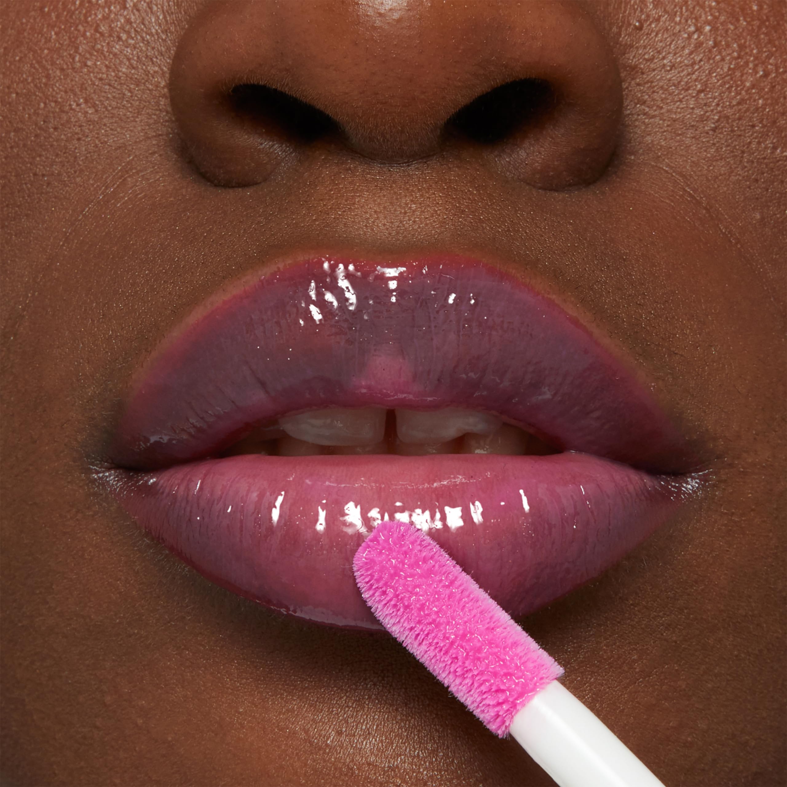 MAYBELLINE gloss tucked in a makeup bag in a lifestyle scene, shows travel-ready convenience