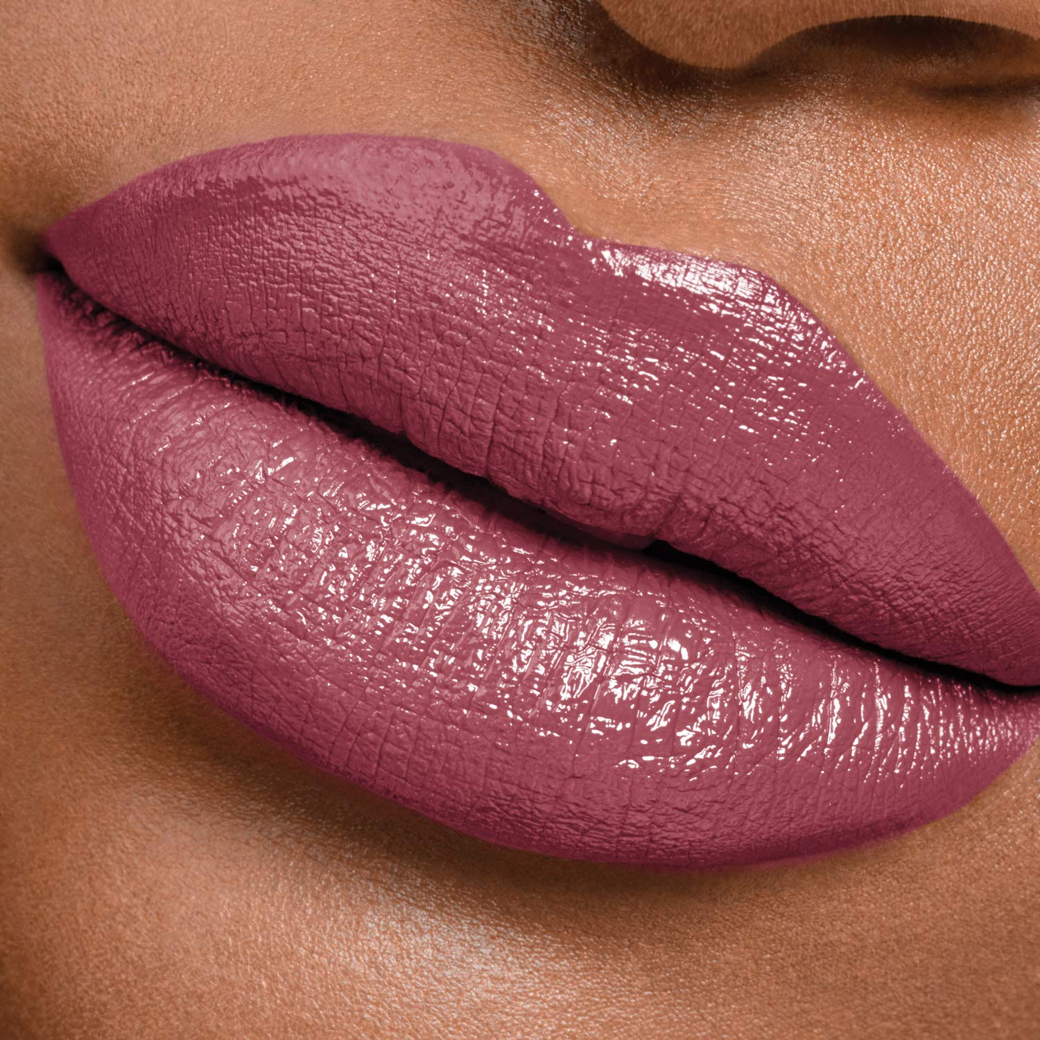 Maybelline model applying lipstick demonstrating effortless use and polished look
