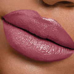 Maybelline model applying lipstick demonstrating effortless use and polished look