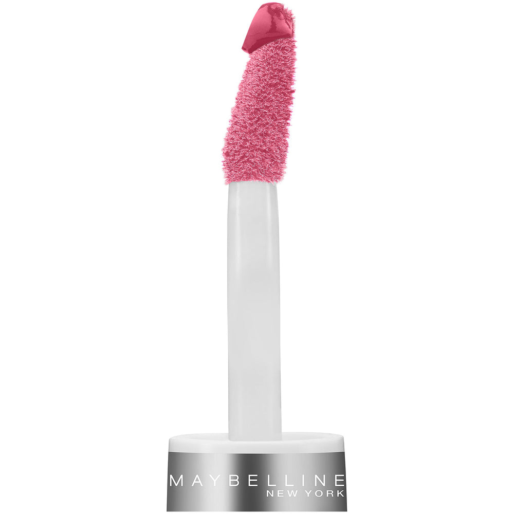 Maybelline tube next to coin for scale demonstrating compact size benefit: travel-friendly