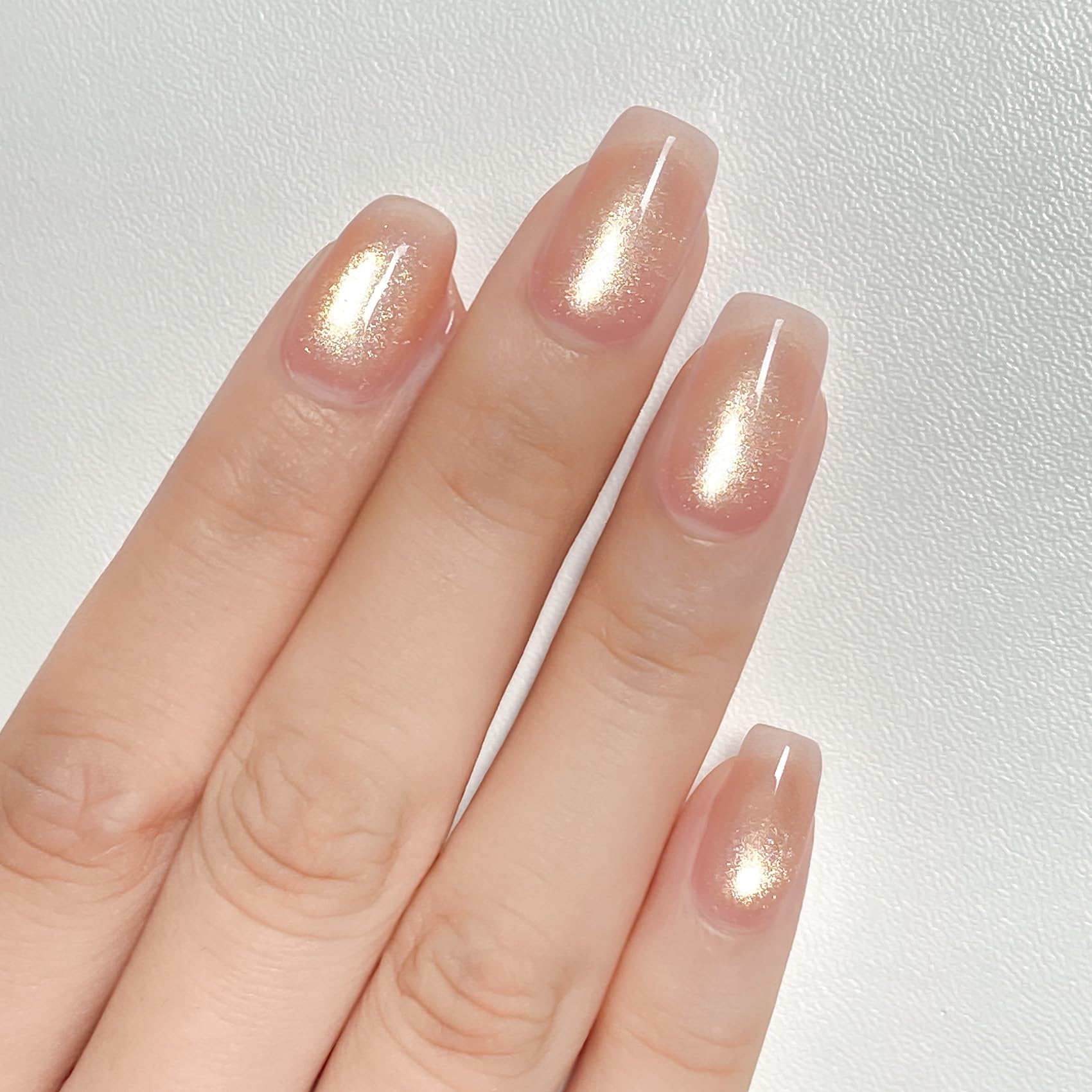 MAYCHAO ash blonde on model nails studio shot offering refined rose-gold finish