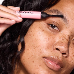 MCoBeauty application on model closeup demonstrating lifted laminated brows and neat hold