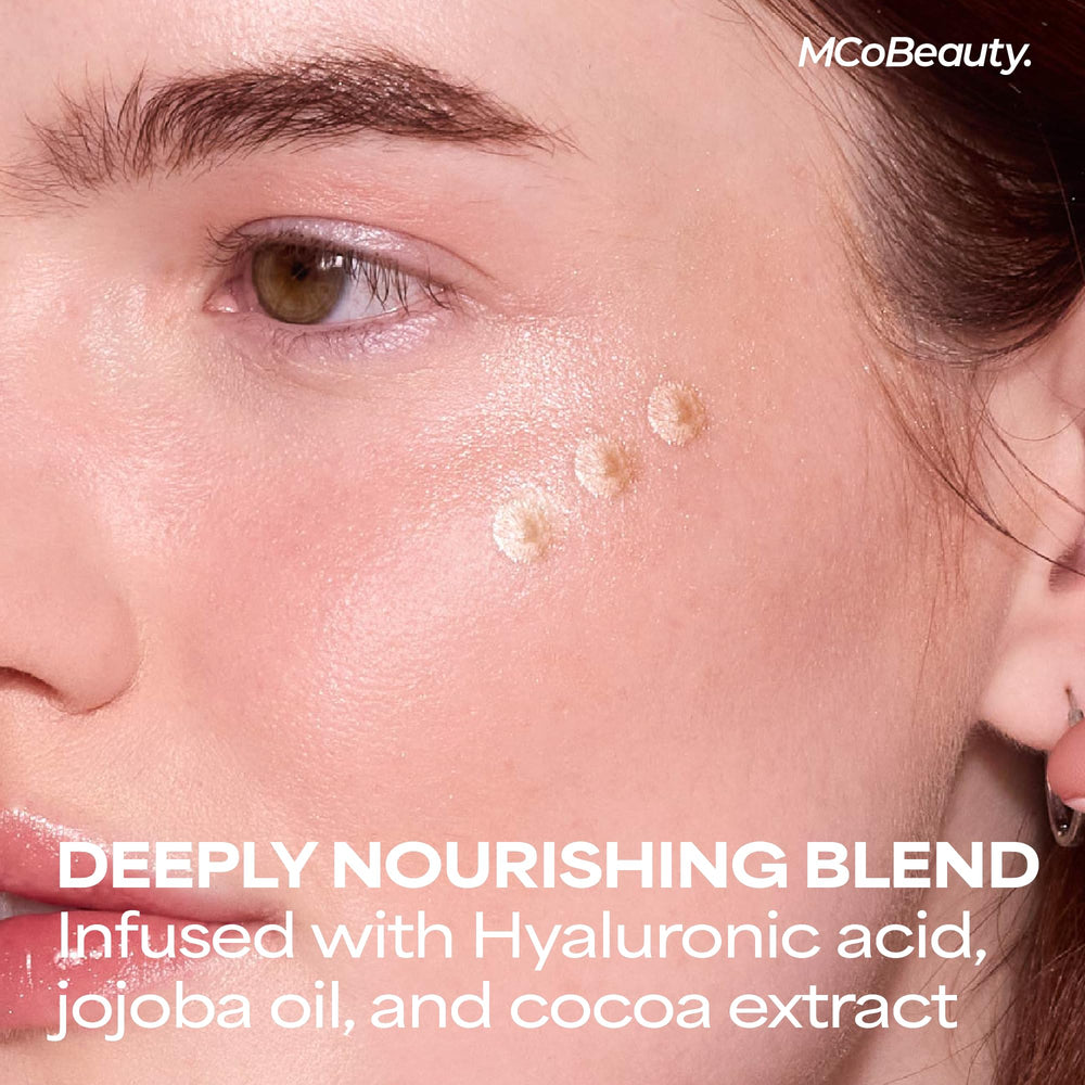MCoBeauty model applying drops to cheekbone for natural radiance