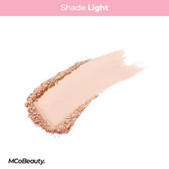 Pressing MCoBeauty Light with a puff under the eye to bake and lock concealer for long wear