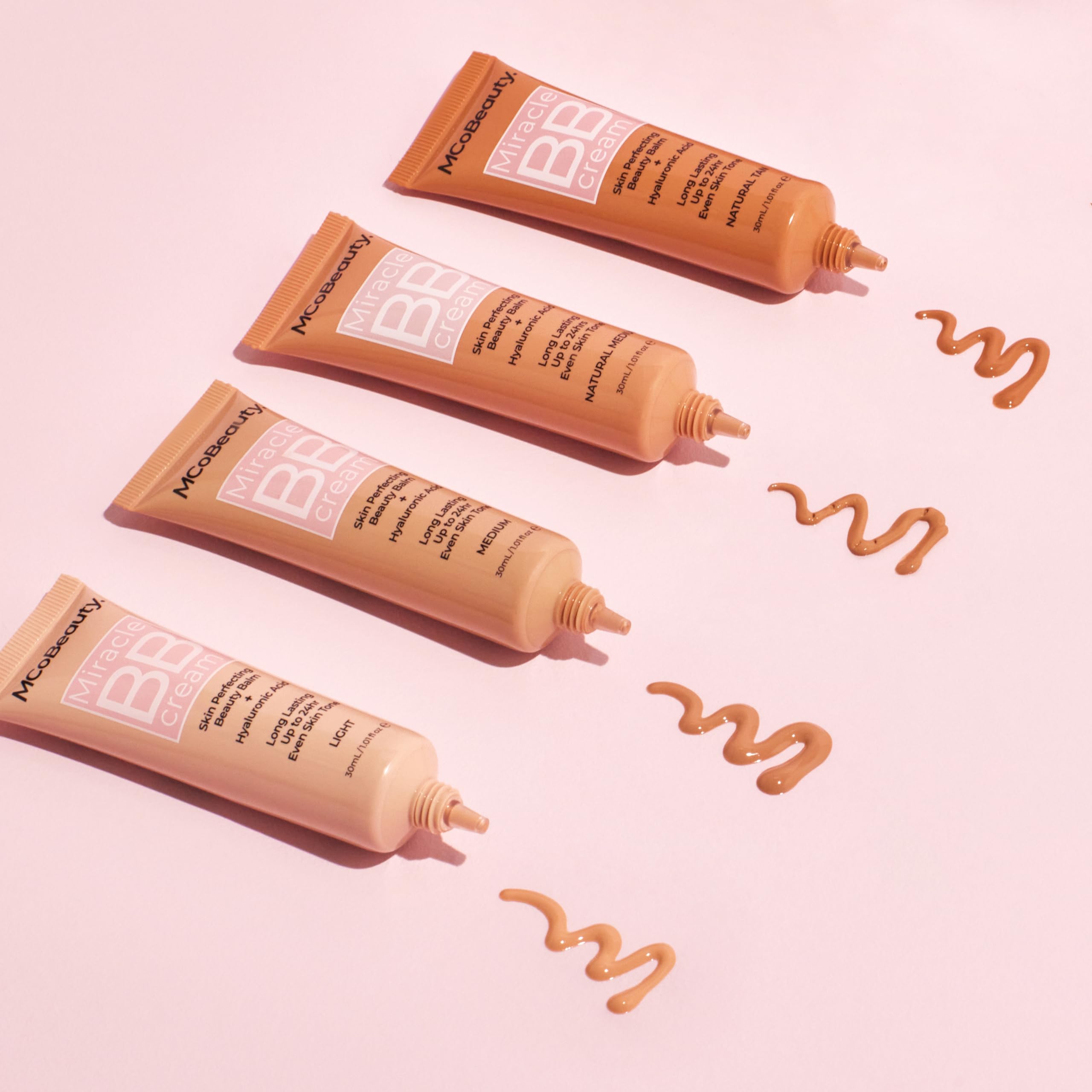 MCoBeauty application with fingers pressing BB cream into skin for natural glow