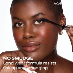 MCoBeauty open mascara tube revealing deep black-brown pigment and smooth formula