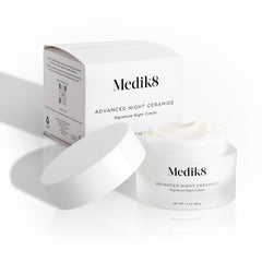Medik8 jar on bathroom counter at night suggesting bedtime routine and restorative benefit