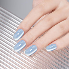 MEGIOR nail swatch on fingers displaying shifting blue holographic finish