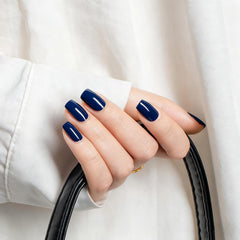 MEGIOR nail swatch on hand displaying deep navy color and salon-quality shine benefit