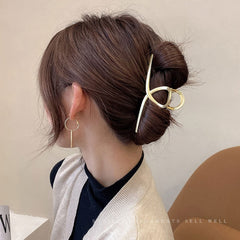 Mehayi in-use securing an updo with firm, comfortable hold benefit