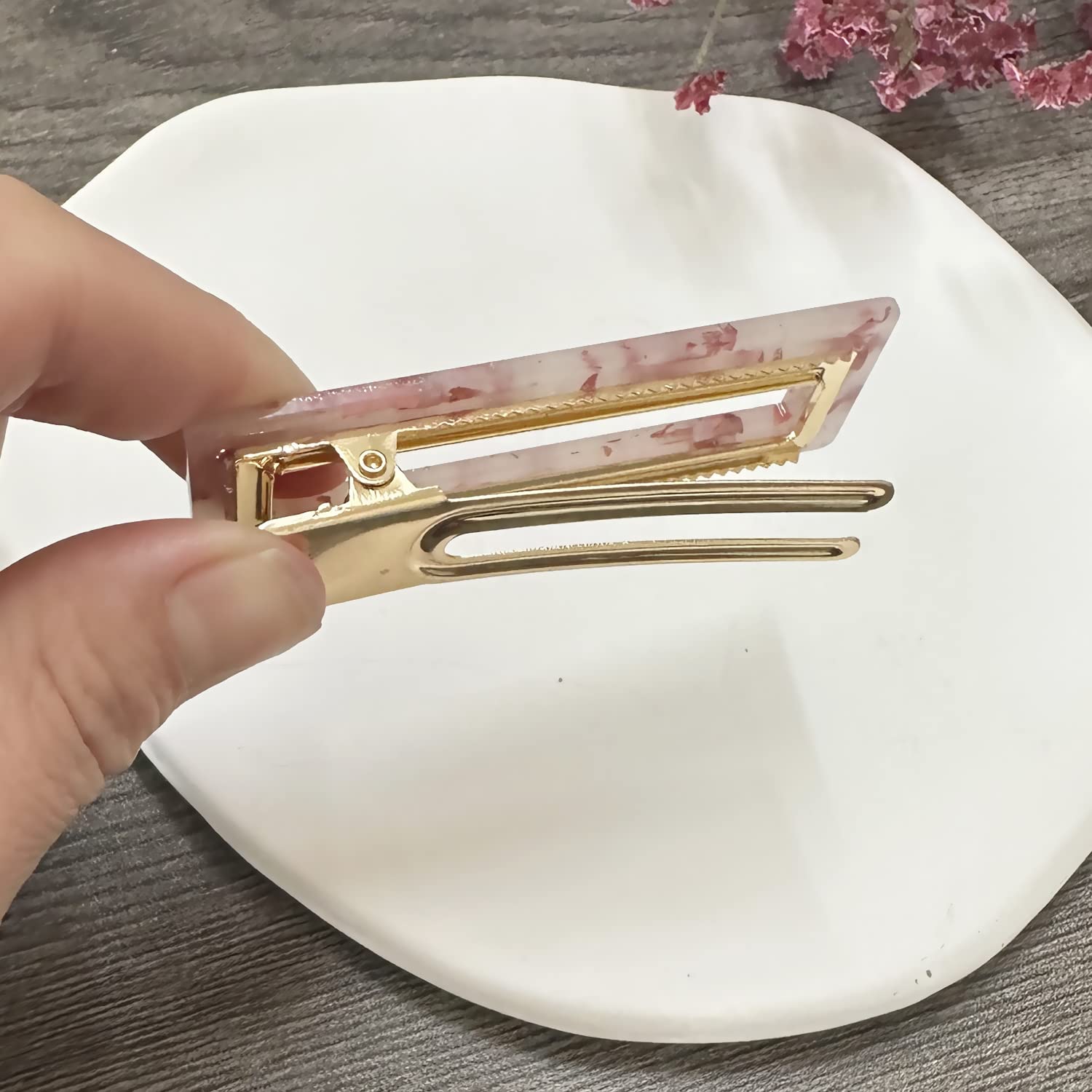 Mehayi clips held in hand for scale showing size and portability benefit travel convenience